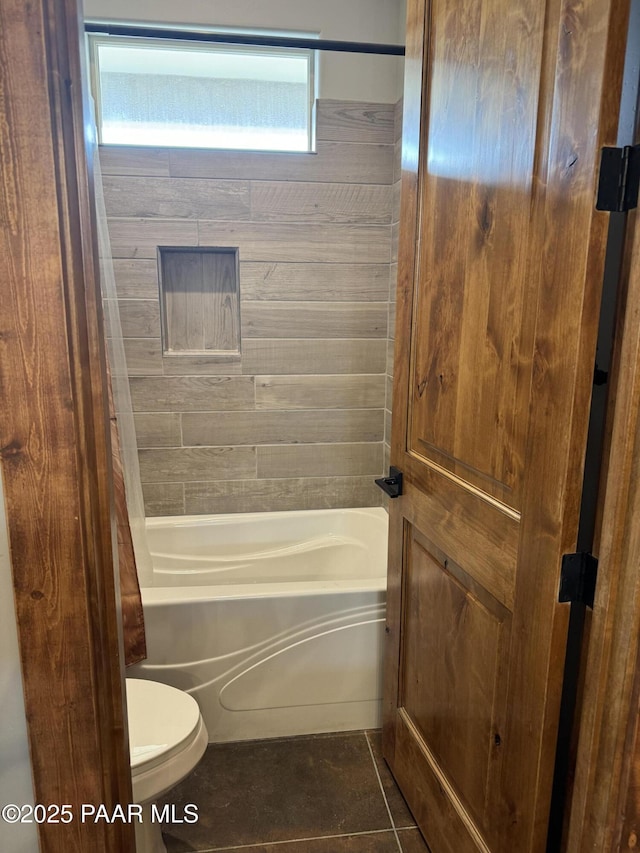 bathroom with shower / tub combo with curtain, tile patterned flooring, and toilet