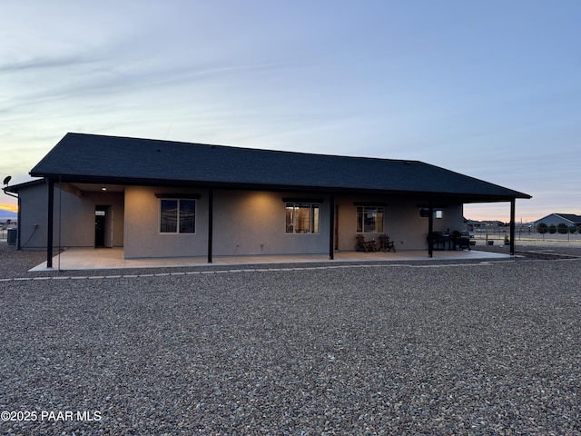 view of front of property with a patio area and central air condition unit