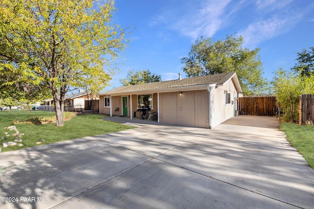 ranch-style home featuring a front yard