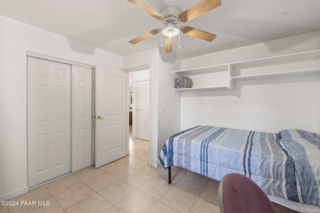 tiled bedroom with a closet and ceiling fan