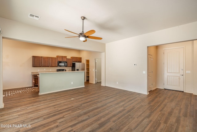 unfurnished living room with ceiling fan and dark wood-type flooring