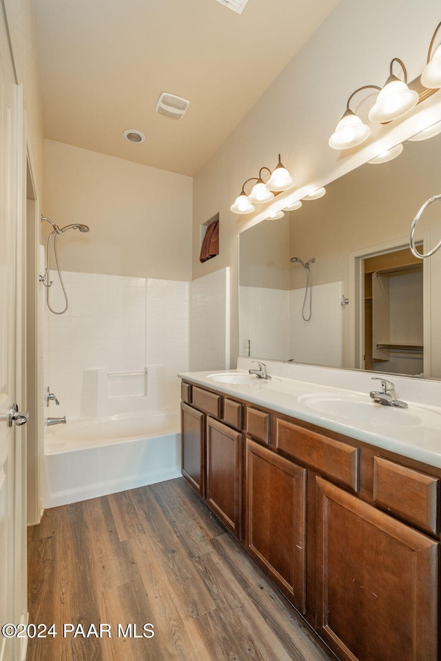 bathroom with vanity,  shower combination, and hardwood / wood-style flooring