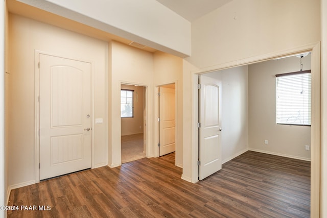 unfurnished room featuring dark wood-type flooring