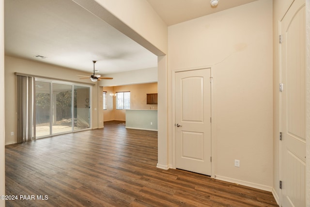 unfurnished living room with dark hardwood / wood-style floors and ceiling fan