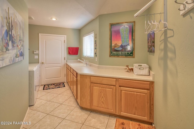 kitchen with light tile patterned flooring, sink, and washer / clothes dryer