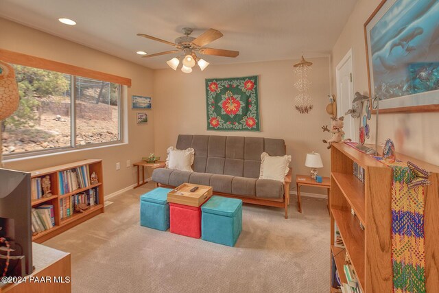 carpeted living room featuring ceiling fan