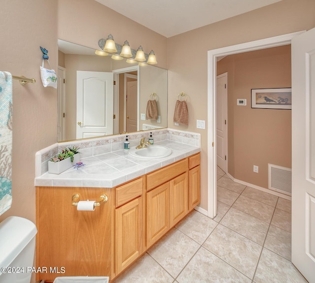 bathroom with tile patterned floors, vanity, and toilet