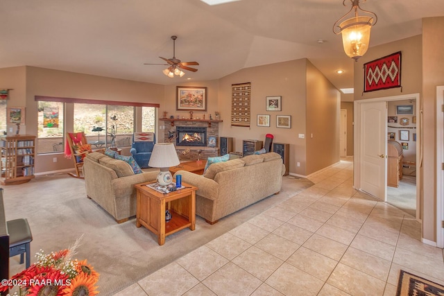 living room with light tile patterned floors, ceiling fan, and lofted ceiling