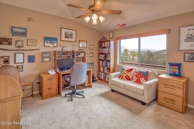 home office featuring light carpet, ceiling fan, and lofted ceiling