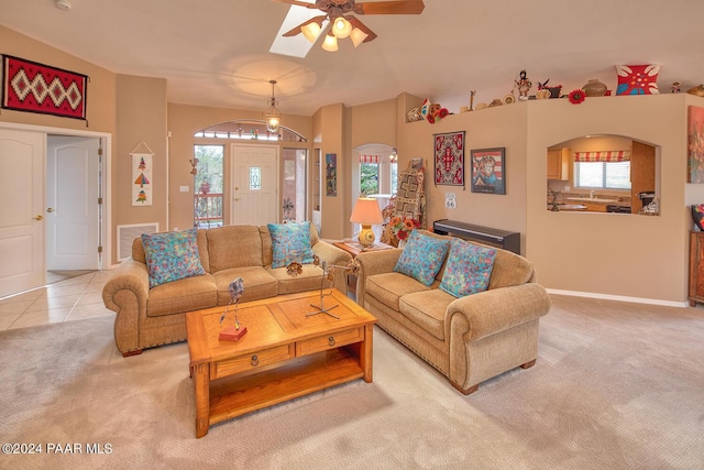 carpeted living room with ceiling fan and a healthy amount of sunlight