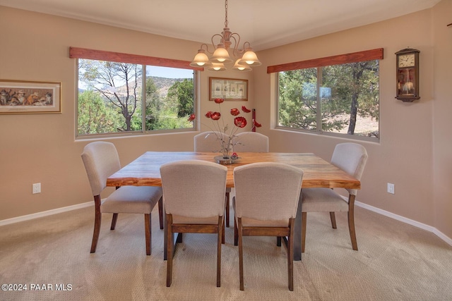 carpeted dining room with an inviting chandelier and a healthy amount of sunlight