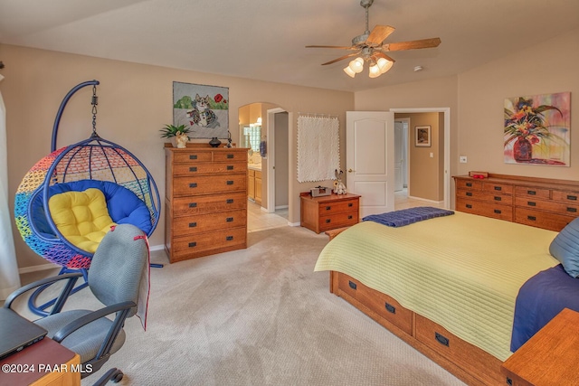 bedroom with ensuite bathroom, ceiling fan, lofted ceiling, and light colored carpet