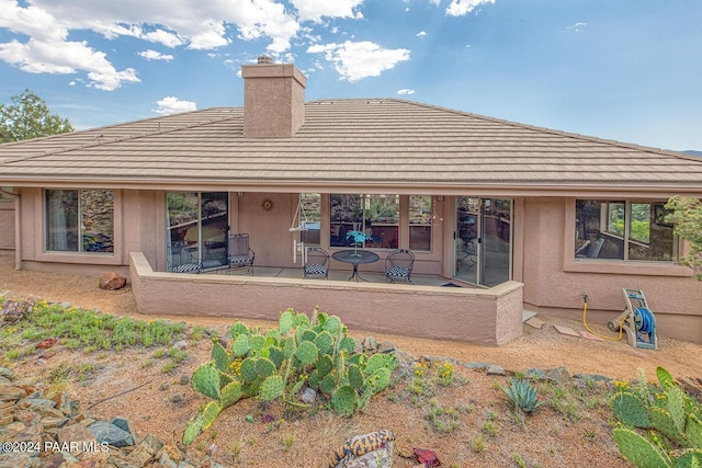 back of property with a patio