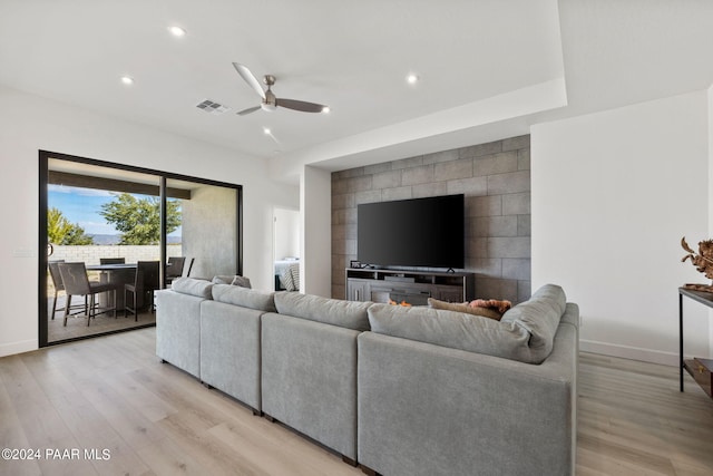 living room with ceiling fan and light hardwood / wood-style floors