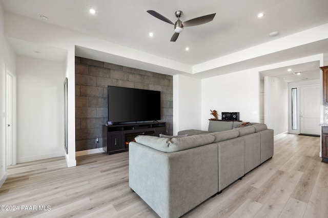 living room featuring light hardwood / wood-style flooring and ceiling fan