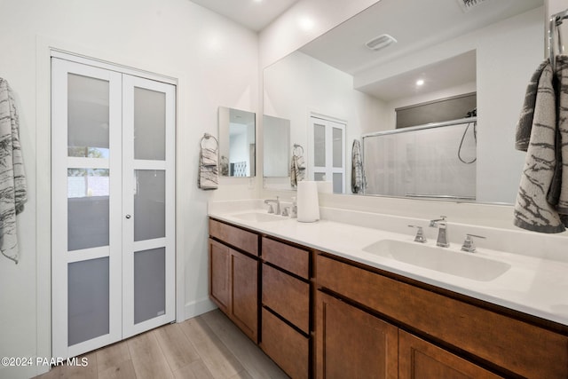 bathroom with vanity, wood-type flooring, and walk in shower