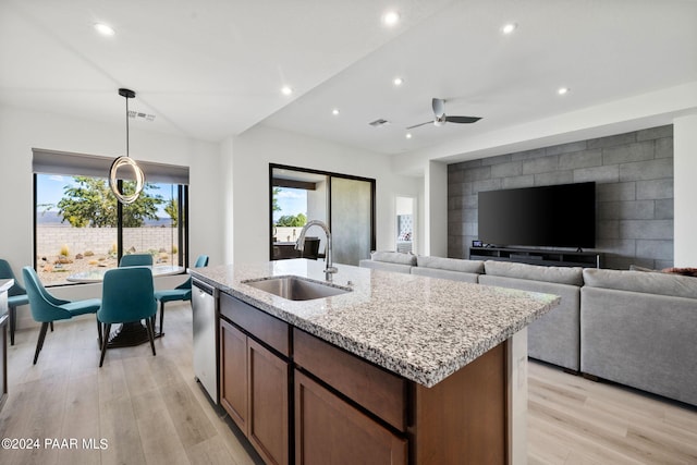 kitchen featuring plenty of natural light, light wood-type flooring, and sink