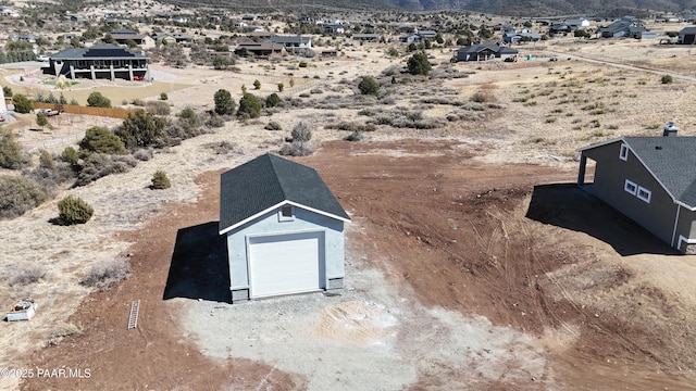 drone / aerial view featuring a desert view and a mountain view