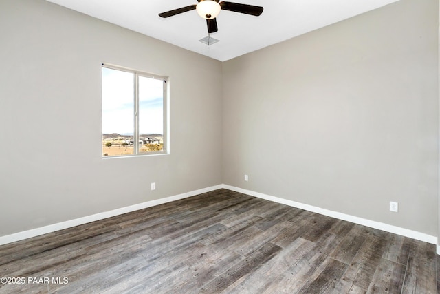 unfurnished room with wood finished floors, a ceiling fan, and baseboards