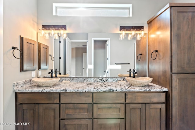 full bathroom with double vanity and a sink