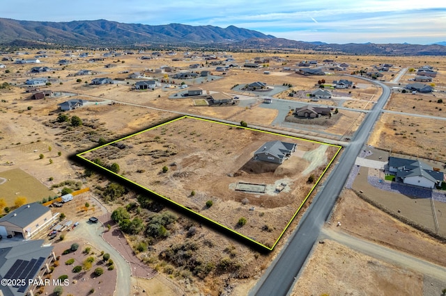 birds eye view of property featuring view of desert and a mountain view