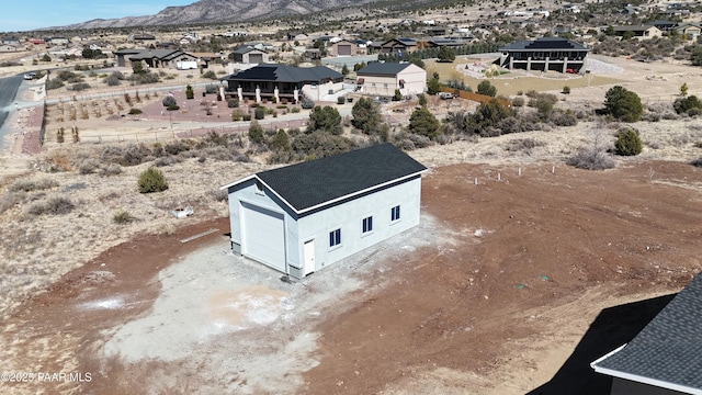 drone / aerial view featuring a residential view and a mountain view