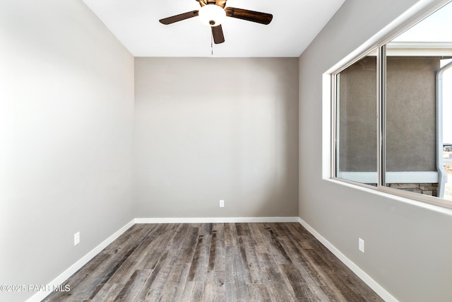 unfurnished room featuring ceiling fan, baseboards, and wood finished floors