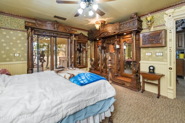 bedroom with carpet flooring, ceiling fan, access to exterior, and wooden walls