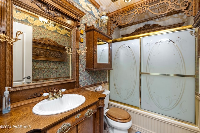 full bathroom featuring shower / bath combination with glass door, vanity, and toilet