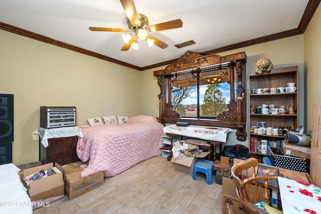 bedroom with light hardwood / wood-style floors, ceiling fan, and crown molding