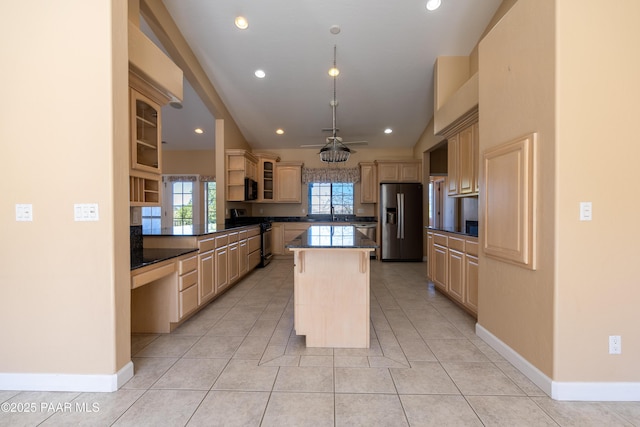kitchen featuring recessed lighting, stainless steel appliances, light brown cabinets, glass insert cabinets, and a center island