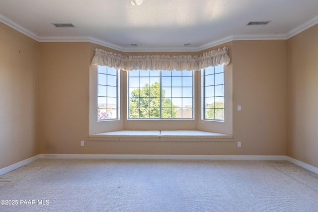 carpeted spare room with visible vents, crown molding, and baseboards