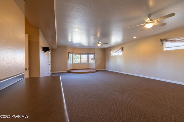 carpeted empty room with baseboards, recessed lighting, ceiling fan, and plenty of natural light