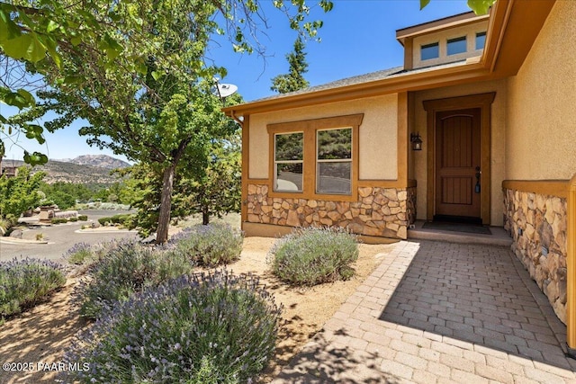 532 Goshawk Trl, Prescott, AZ 86301 - doorway to property with stucco siding, stone siding, and a mountain view