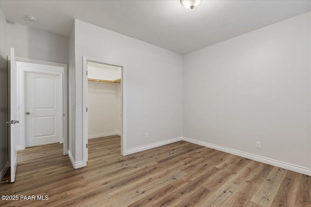 532 Goshawk Trl, Prescott, AZ 86301 - unfurnished bedroom featuring light wood-type flooring, a closet, and a spacious closet