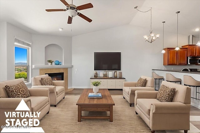 532 Goshawk Trl, Prescott, AZ 86301 - living room featuring ceiling fan, a chandelier, light wood finished floors, lofted ceiling, and a tiled fireplace