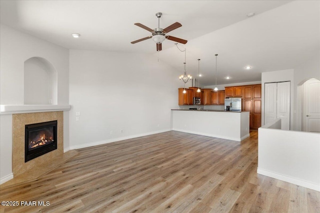 532 Goshawk Trl, Prescott, AZ 86301 - unfurnished living room with ceiling fan, recessed lighting, light wood finished floors, lofted ceiling, and a fireplace