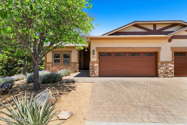 532 Goshawk Trl, Prescott, AZ 86301 - view of front facade with stone siding, stucco siding, a garage, and decorative driveway