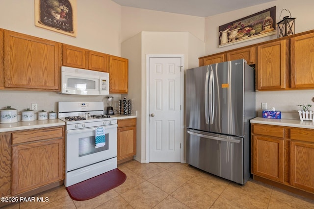 4034 N Sheridan Ln, Prescott Valley, AZ 86314 - kitchen featuring white appliances, light countertops, brown cabinets, and light tile patterned floors