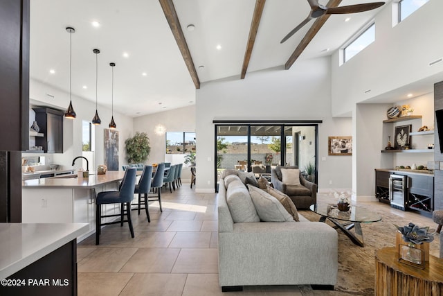 tiled living room with beam ceiling, high vaulted ceiling, and a healthy amount of sunlight