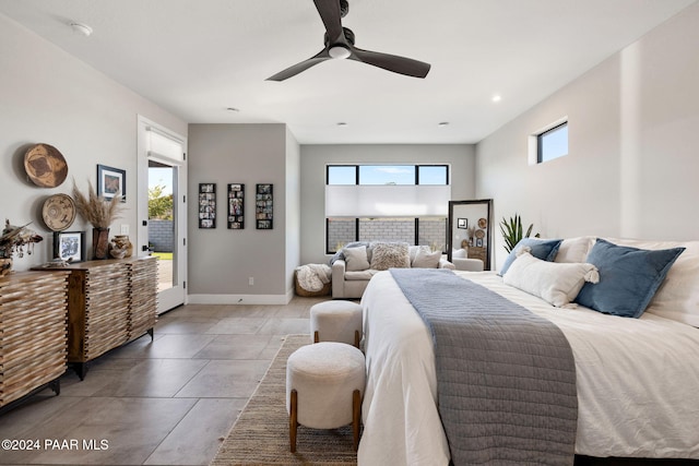 tiled bedroom featuring multiple windows, ceiling fan, and access to exterior