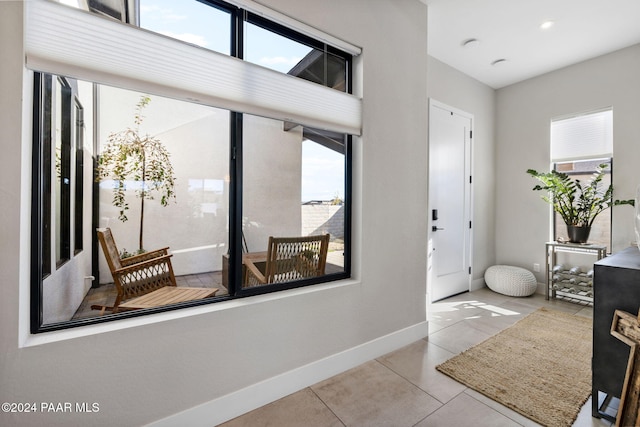 entryway with light tile patterned floors and a healthy amount of sunlight