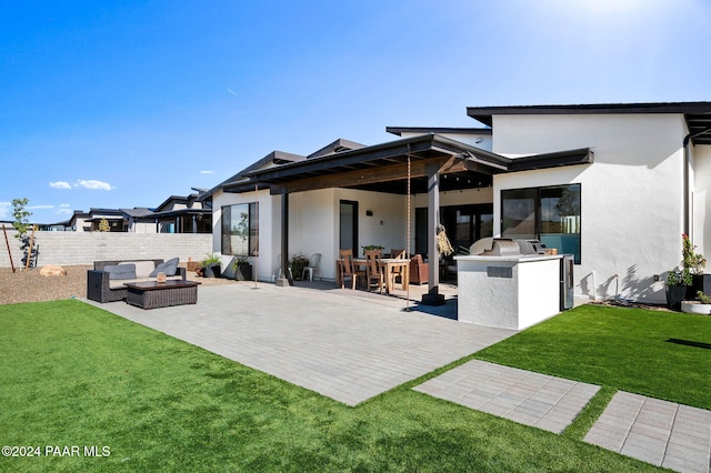 rear view of property featuring a lawn, area for grilling, an outdoor living space, and a patio