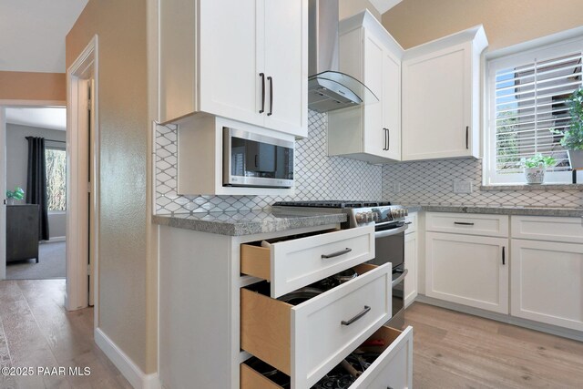 26647 N 43rd St, Cave Creek, AZ 85331 - kitchen featuring wall chimney range hood, stainless steel appliances, decorative backsplash, and light wood finished floors
