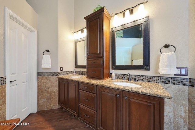 26647 N 43rd St, Cave Creek, AZ 85331 - bathroom with tile walls, double vanity, a wainscoted wall, and wood finished floors