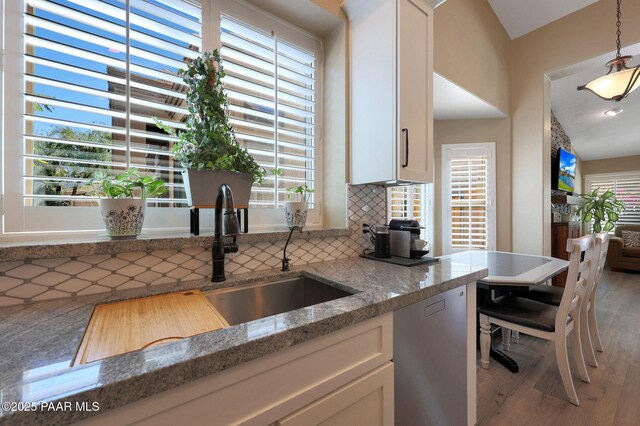 26647 N 43rd St, Cave Creek, AZ 85331 - kitchen with backsplash, white cabinets, light wood-type flooring, light stone countertops, and pendant lighting