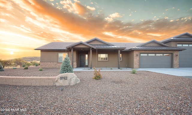 9192 N Doc Bar Rd, Prescott Valley, AZ 86315 - view of front facade featuring stone siding, stucco siding, a standing seam roof, and a garage