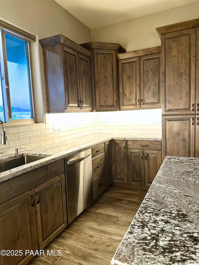 9192 N Doc Bar Rd, Prescott Valley, AZ 86315 - kitchen featuring stainless steel dishwasher, a sink, tasteful backsplash, wood finished floors, and light stone counters