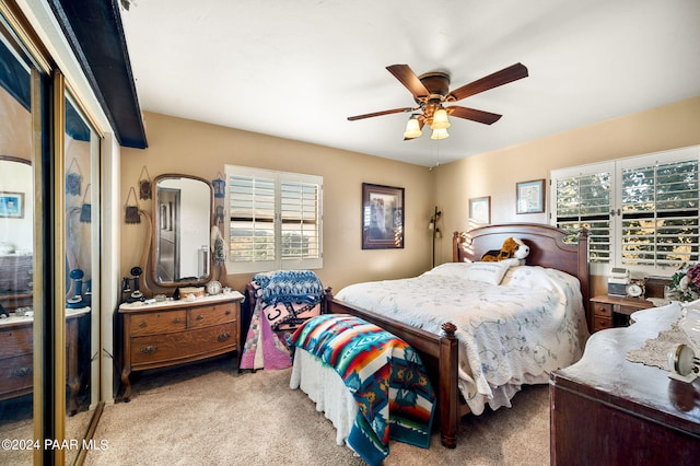 bedroom with ceiling fan and light colored carpet