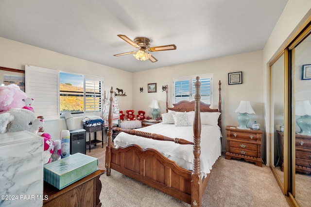 carpeted bedroom featuring a closet and ceiling fan